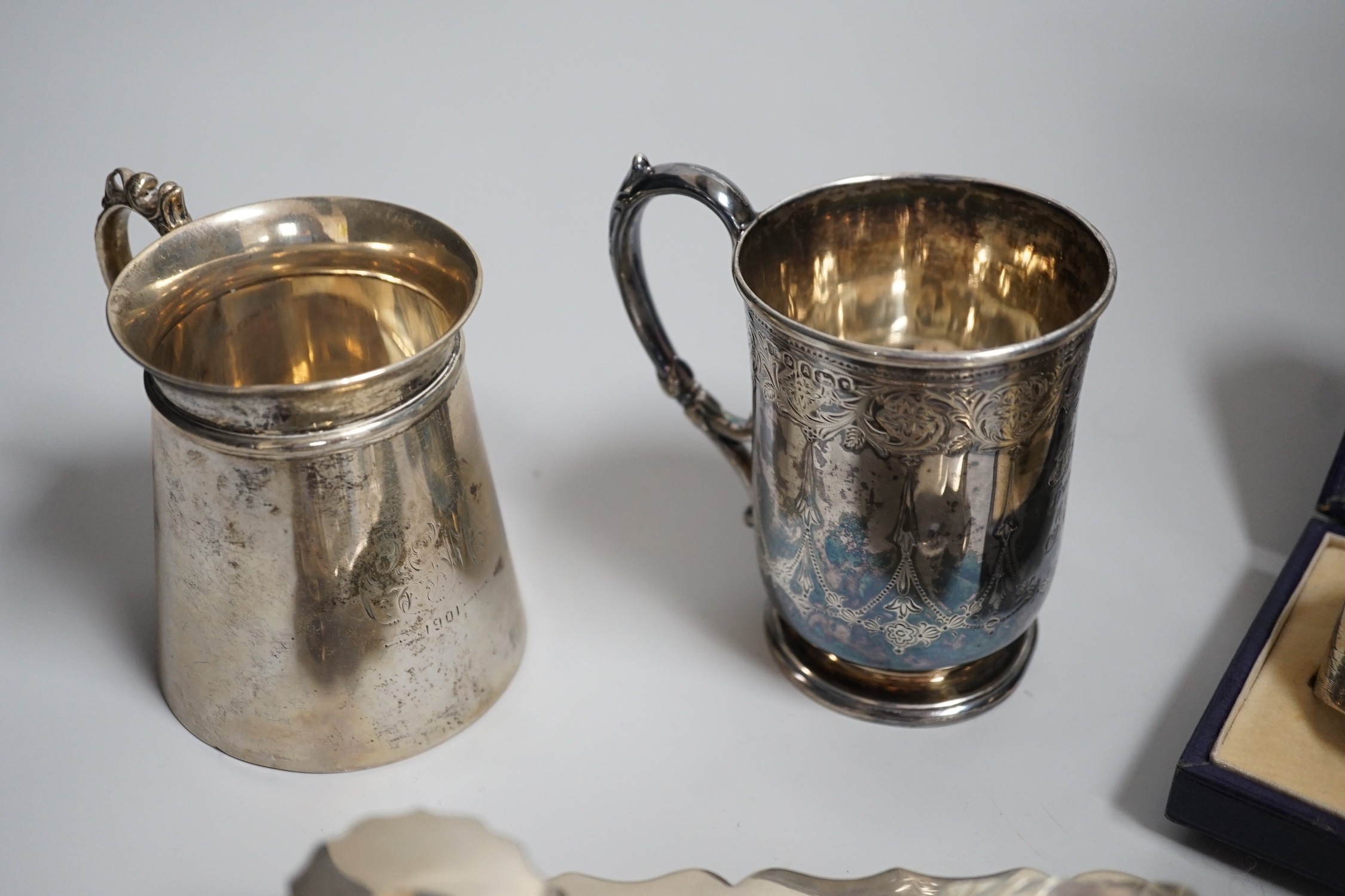 A group of silver including a George V silver inkstand, 17.7cm, a cased pair of napkin rings and two silver christening mugs, one Victorian.